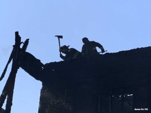 Boston firefighters on roof with ax