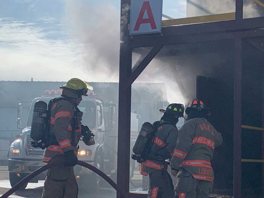 Firefighters participate in hands-on training advancing hoseline