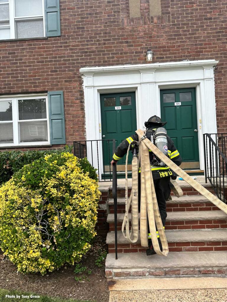 Firefighter with uncharged hoseline at apartment fire in Hasbrouck Heights New Jersey