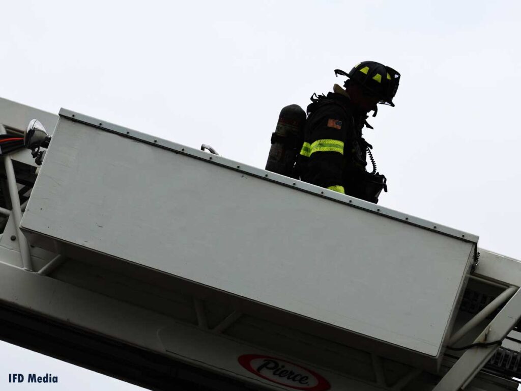 Firefighter descending a ladder