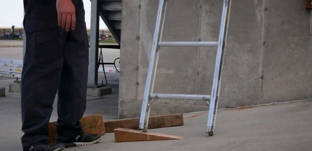 Firefighters use a chock to balance ground ladder