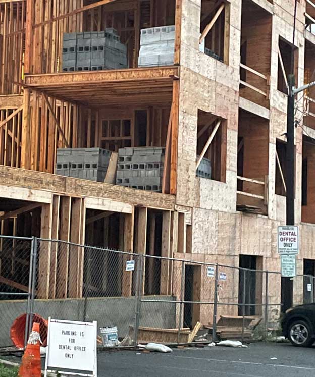 Heavy material stored on floors of building under construction