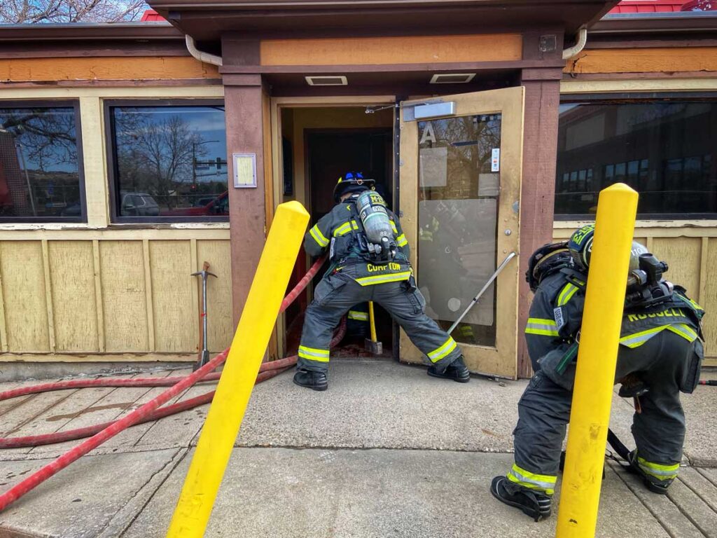 Firefighters stretch inside a restaurant during training