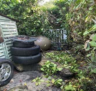 Wire laying on old fence gate on top of tires