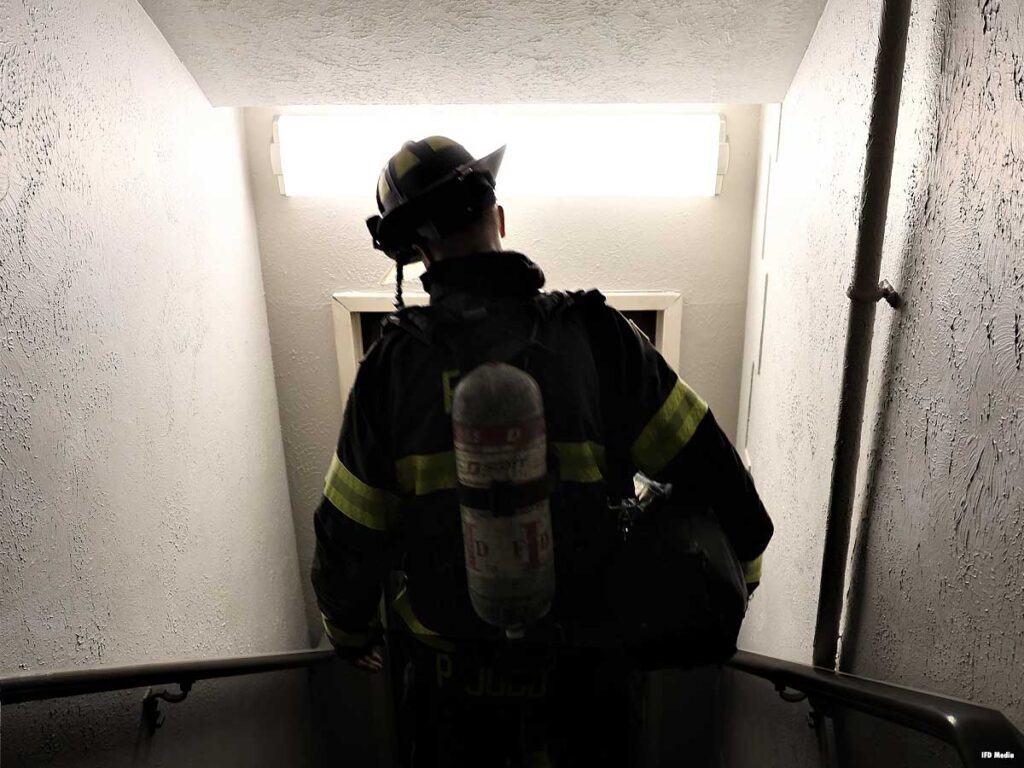 Firefighter descending the stairs