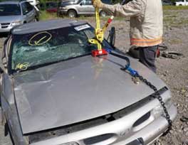 Firefighters training on lifting steering wheel in vehicle rescue