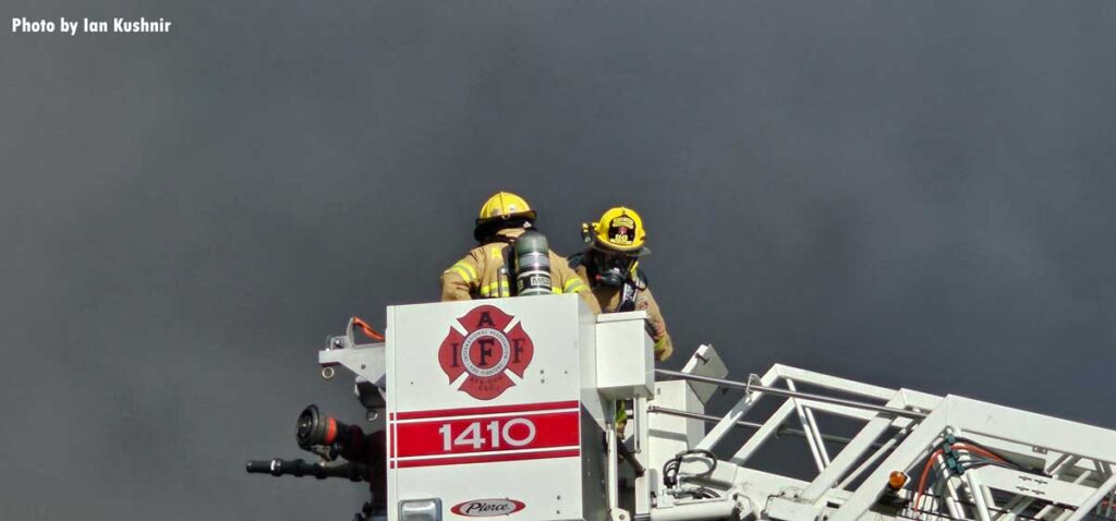 Firefighters in tower ladder bucket