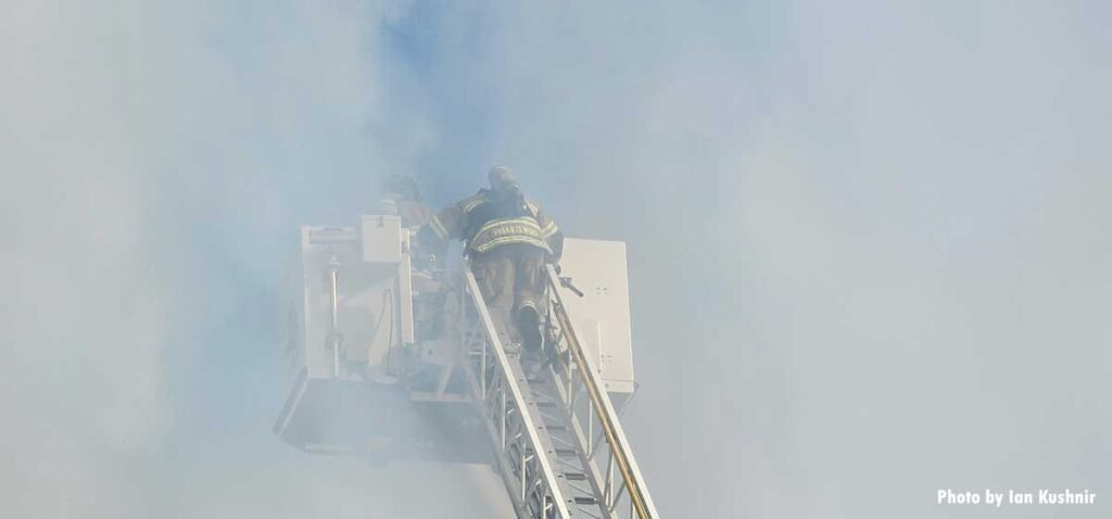 Firefighter in smoke in aerial bucket