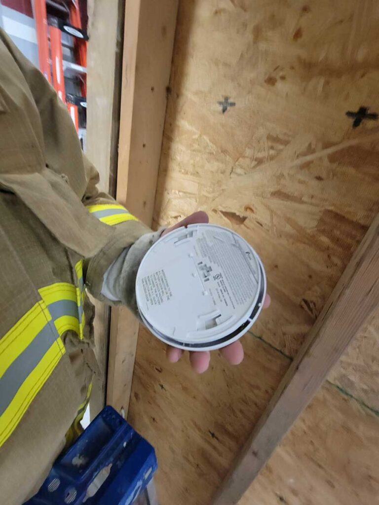 Firefighter with smoke alarm