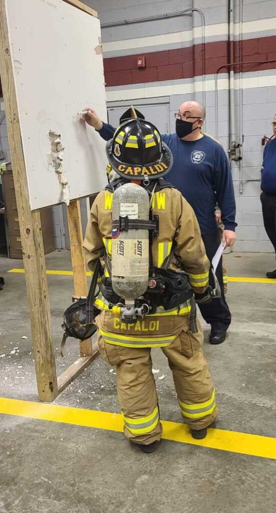 Firefighters training on pulling sheetrock