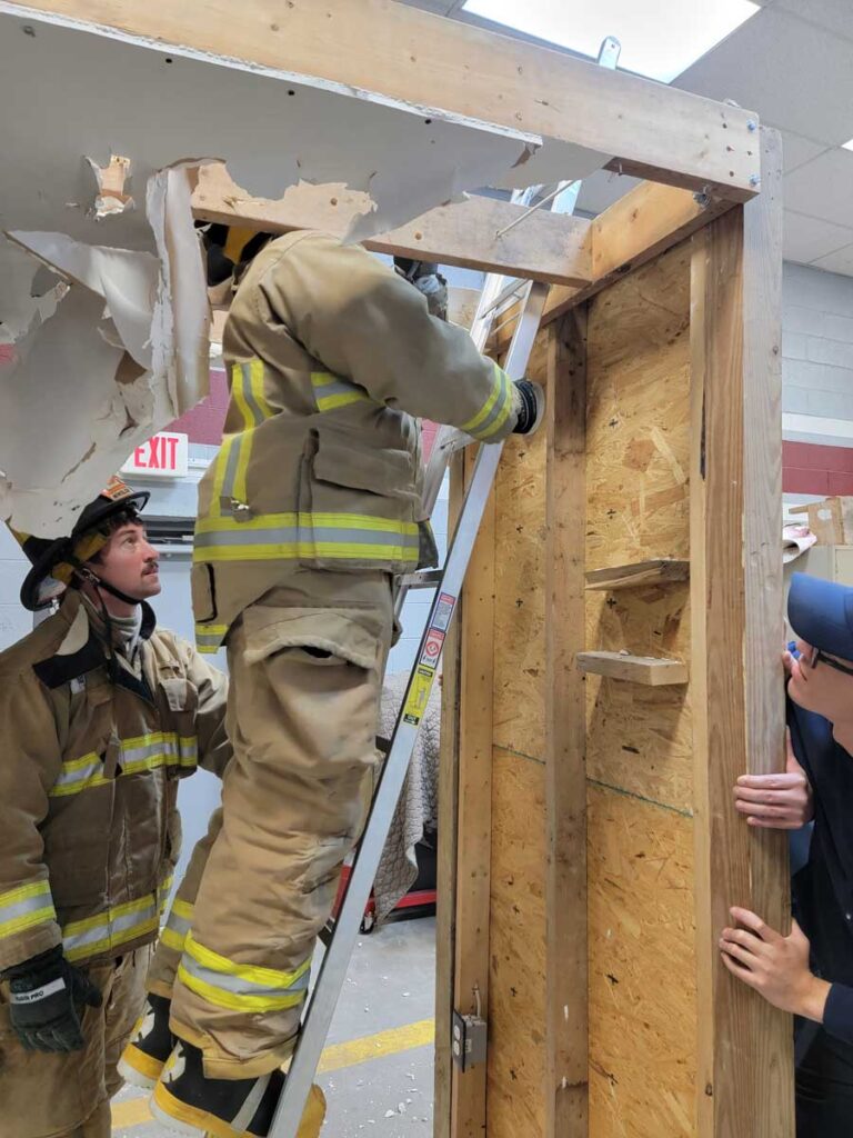 Firefighter on ladder training overhaul on prop