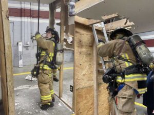 Firefighters training on interior hallway prop