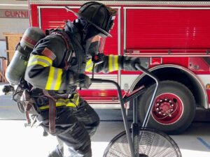 Firefighter on stationary bike