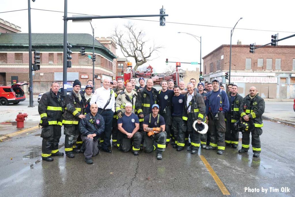 Chicago firefighters pose by truck following fire