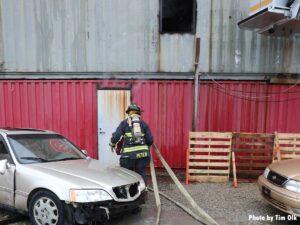 Firefighter stretching a hoseline