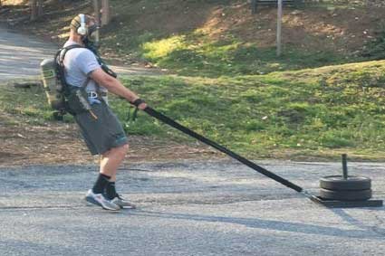 Firefighter pulling weights