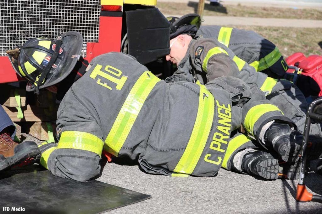 Indianapolis firefighters work to rescue man pinned under bus