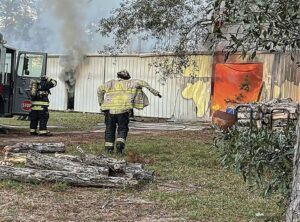 Firefighters at fire with smoke showing