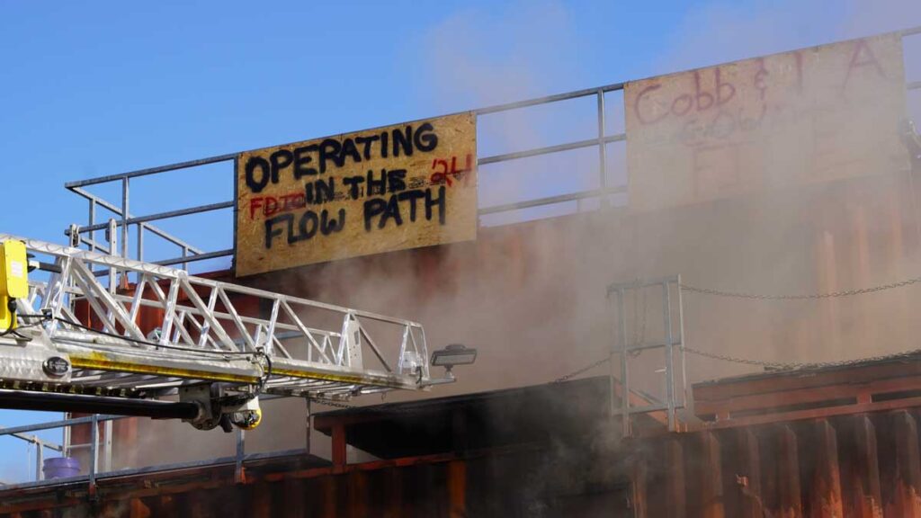 Operating in the flow path training FDIC 2024 with aerial ladder tip