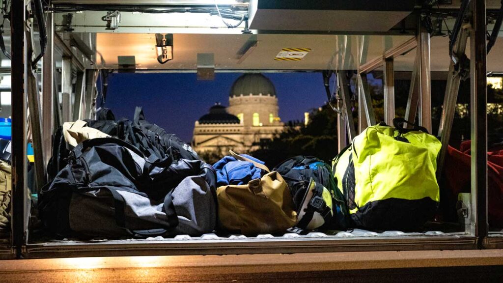 Firefighters gear on bus with Indianapolis capitol in background