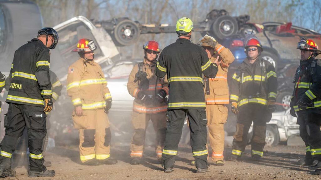 Fire instructor and firefighters during FDIC extrication training