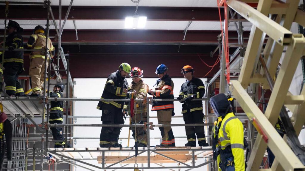 Four firefighters on a suspended platform