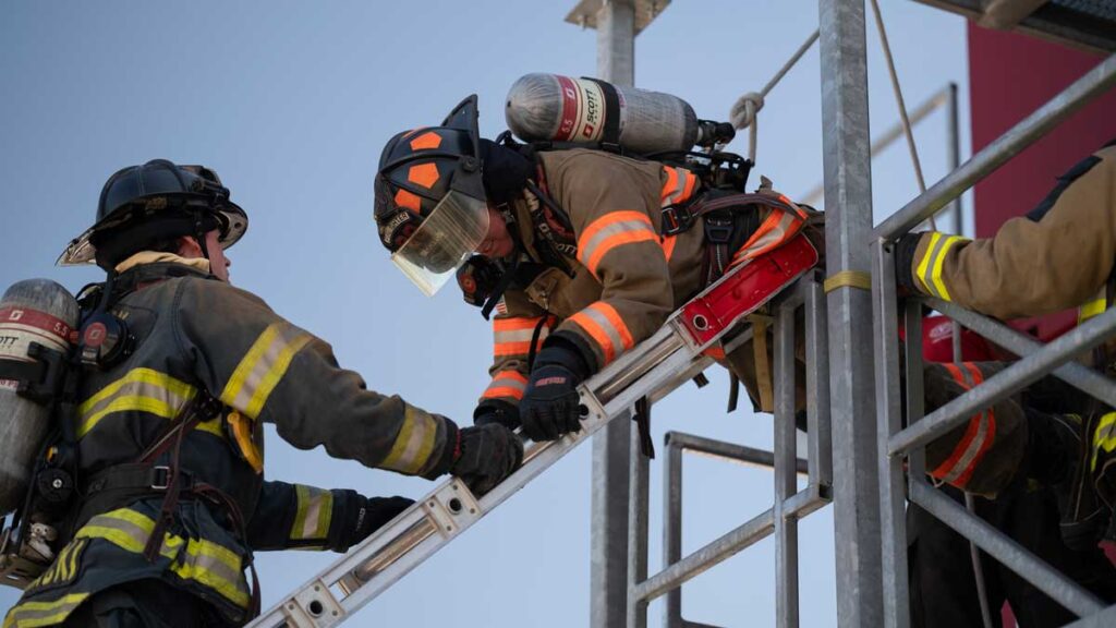 Firefighter climbing down a ladder head first