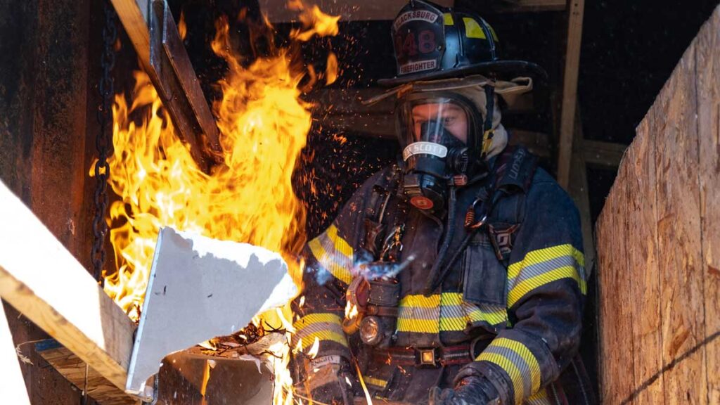 Firefighter in full gear and flames