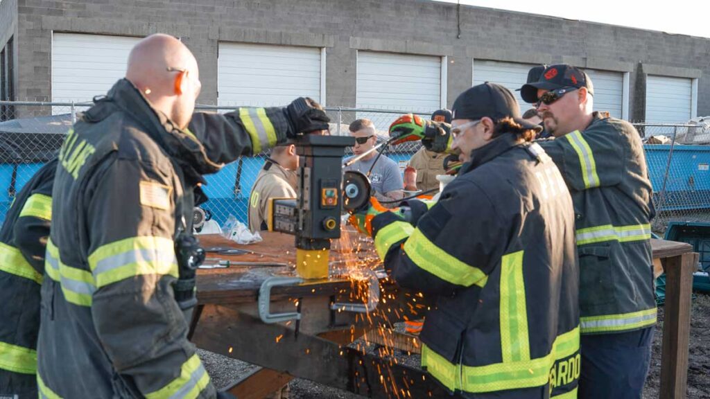 Firefighters using saws for cutting