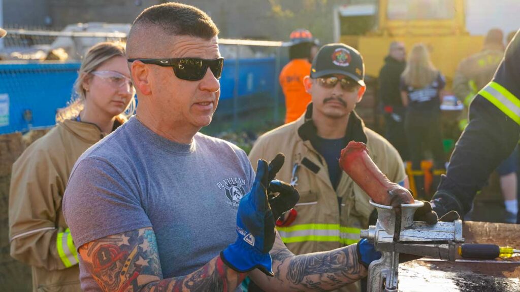 Firefighters with fake limb inside grinder