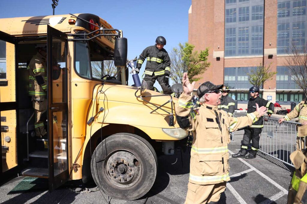 Fire instructor Leigh Hollins with school bus rescue at FDIC 2024