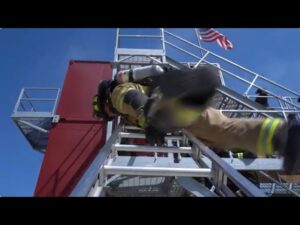 Firefighter swinging on a ladder FDIC 2024