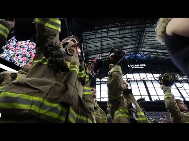 FDIC 2024 Friday firefighters holding up helmets