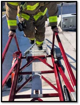 Firefighter traversing ladder