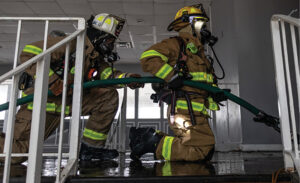 Mayday training firefighters with a hoseline