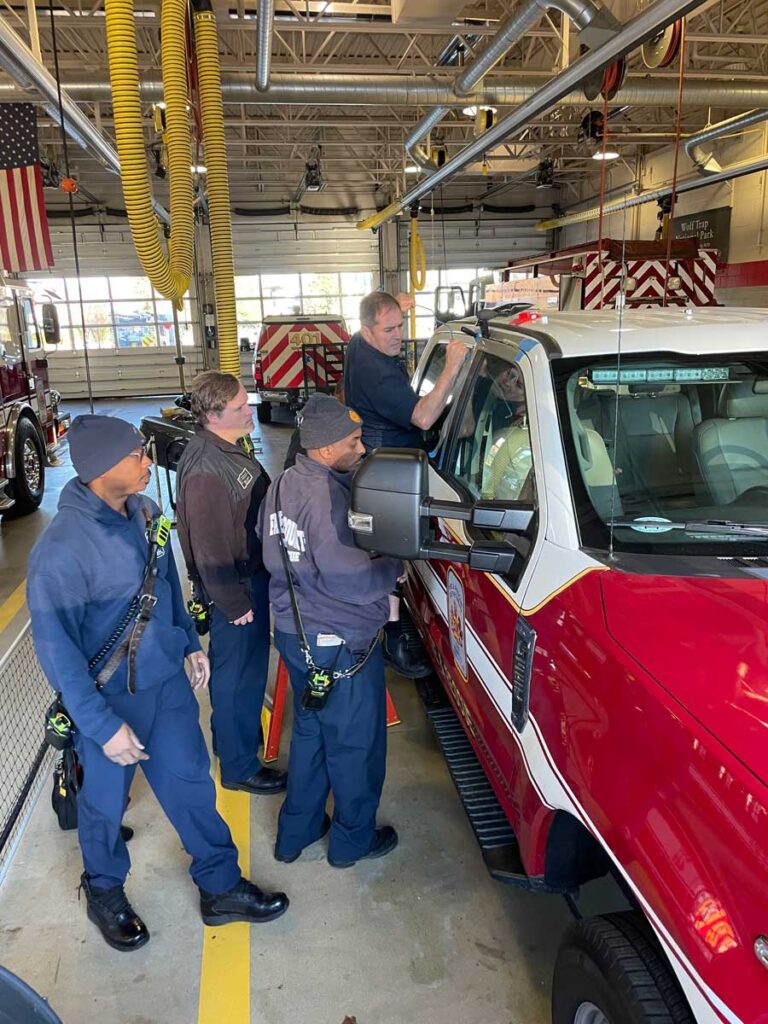 Firefighters working to rescue baby from vehicle during training scenario