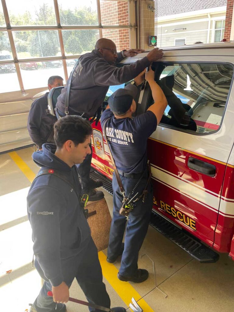 Firefighters force entry on vehicle during training