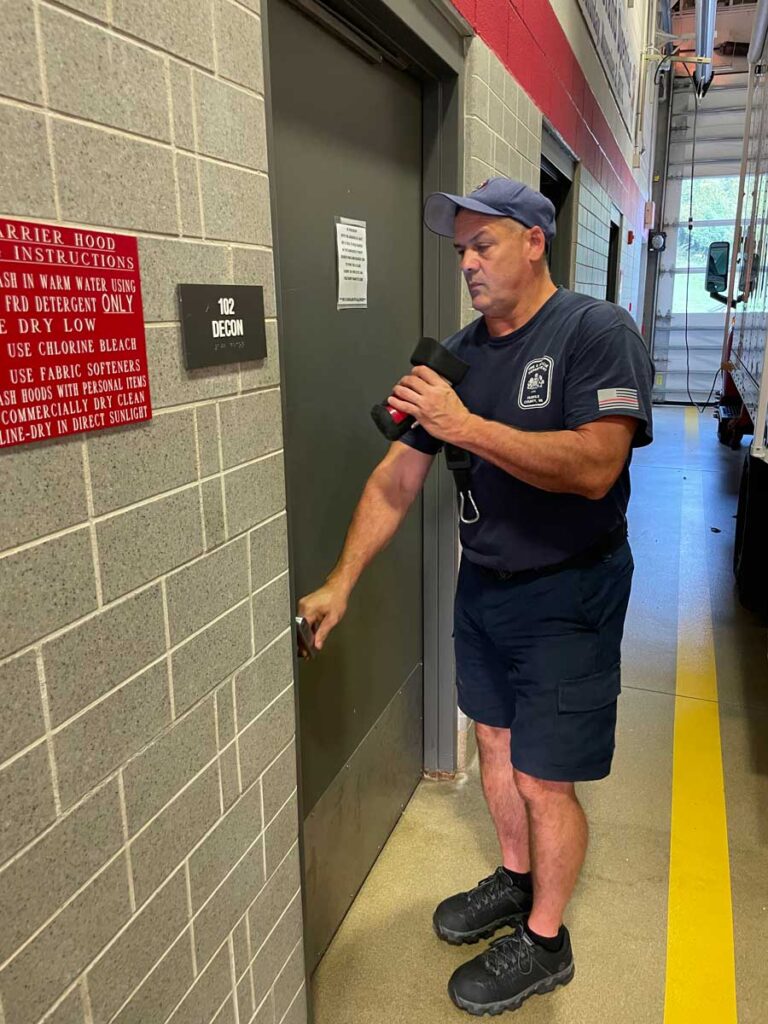 Firefighter at door inside station