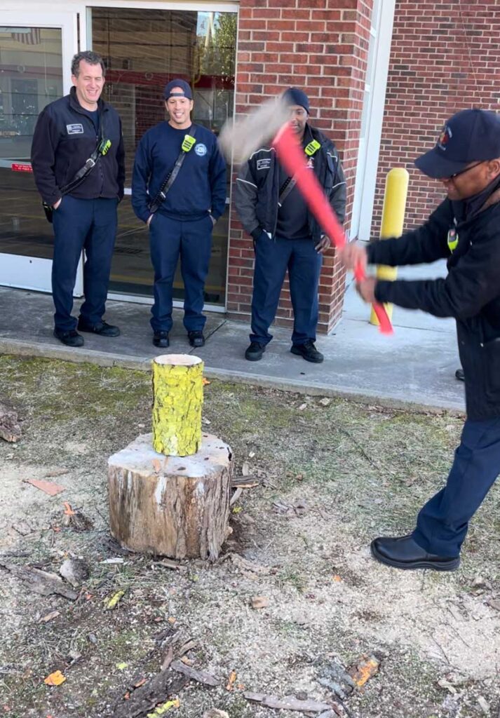 Firefighters splitting log during escape room training