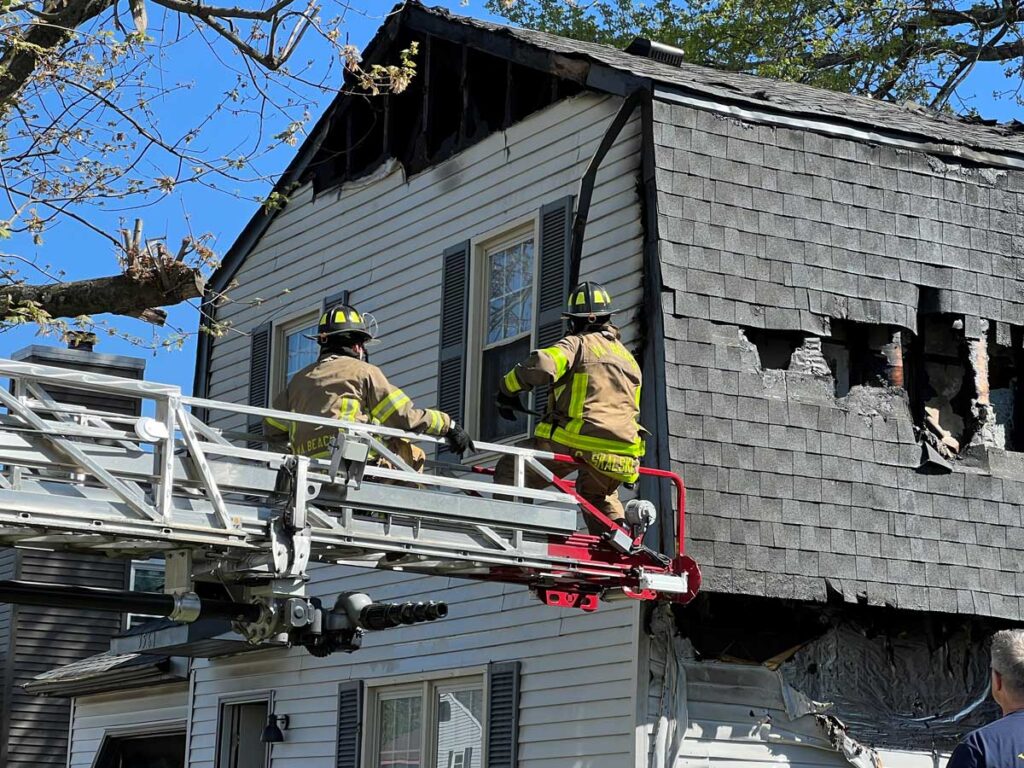 Firefighters operate from aerial ladder tip