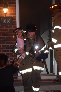 Detroit Firefighters Rescue Three Children from Fire. Photo by Ted Roney.