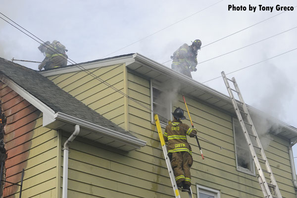 Firefighters operating on the roof of a building