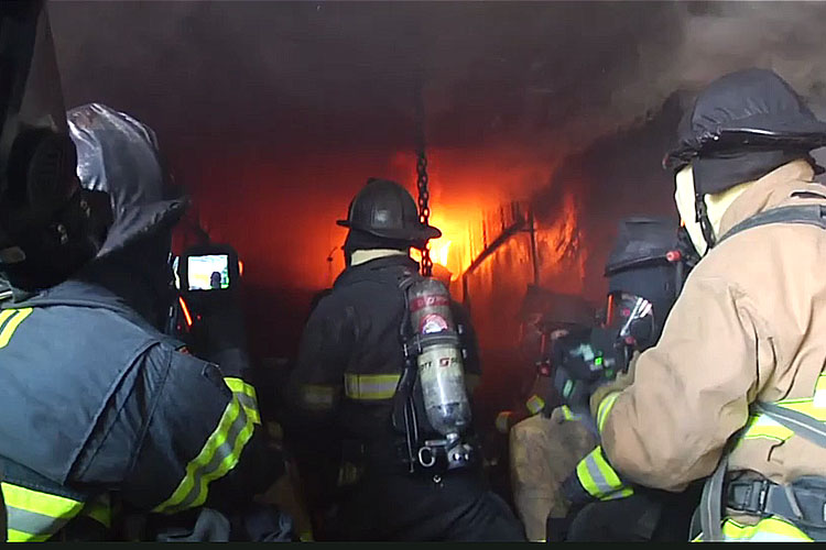 Firefighters in a flashover container with a TIC