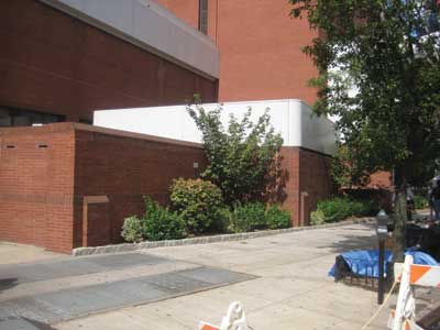 one-story brick addition with the white stripe 