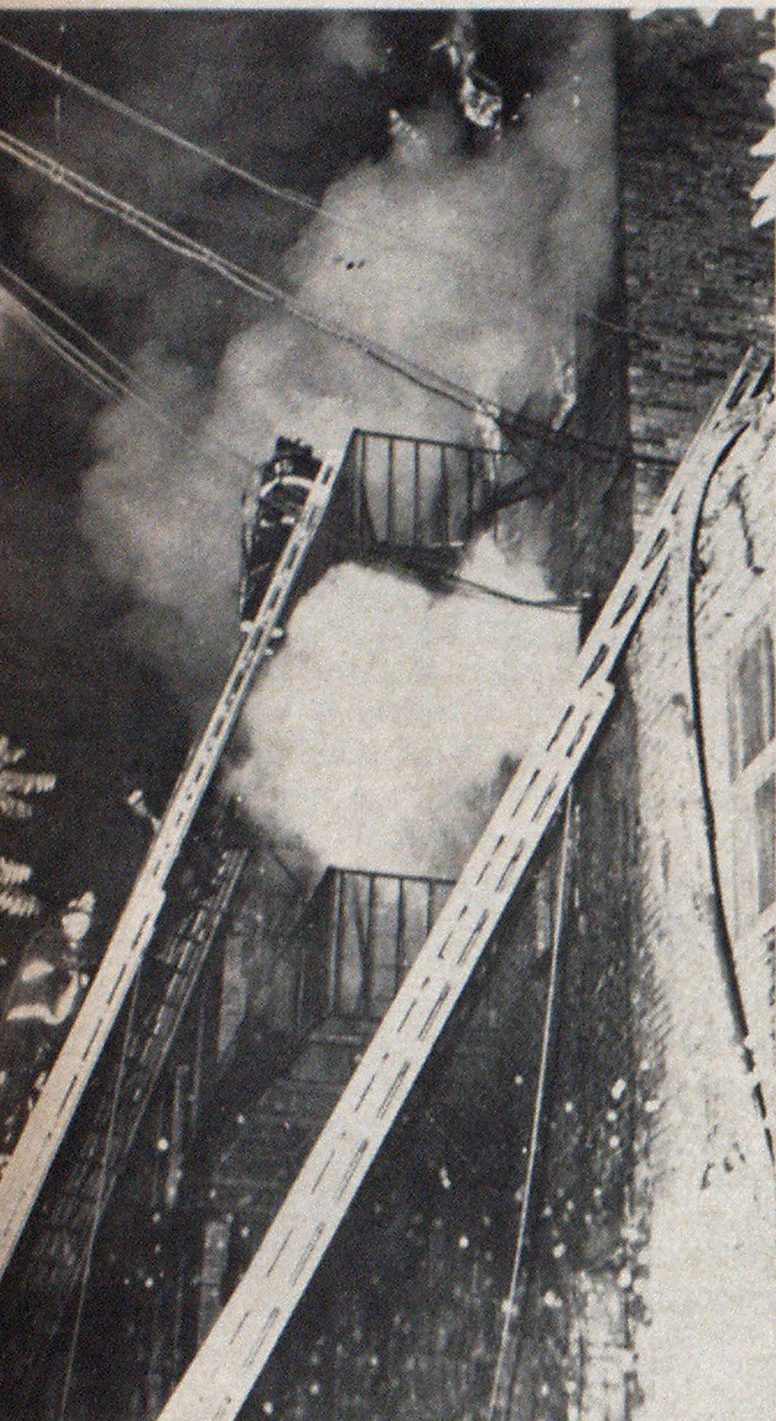 This photo was taken minutes before wall collapse of boston warehouse. Fire fighters were swept from ladder and crushed in narrow 12-foot street