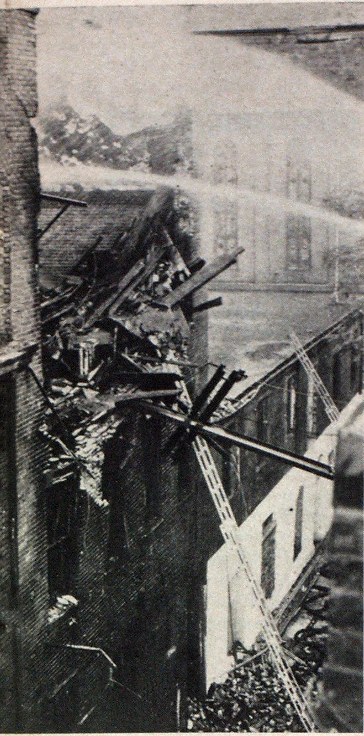 Morning after. Two top floors are a fumbled ruin. Failure of I-beam attached to underside of roof is believed to have triggered collapse